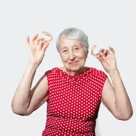 flexible nylon denture on senior female hands. Removable dentures flexible, devoid of nylon, hypoallergenic exempt from monomer